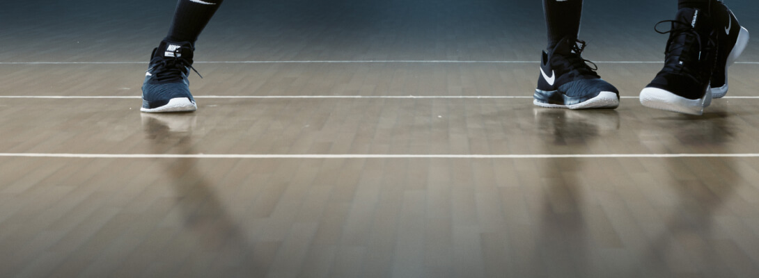 Enkelverband Dirk Nowitzki in basketbal Uitzicht op de vloer van een basketbalzaal en de voeten van twee spelers